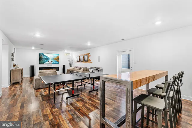 a living room with furniture wooden floor and a table