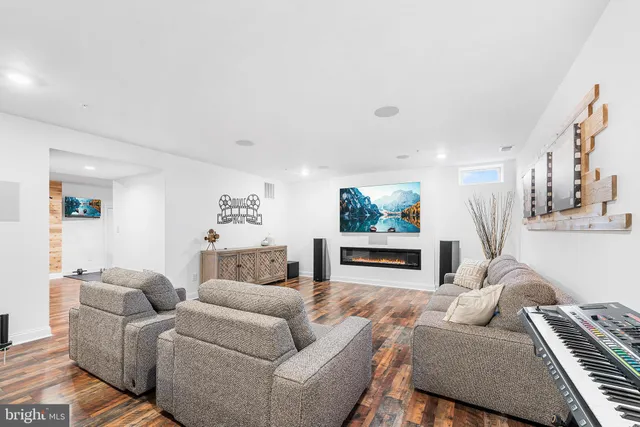 a living room with furniture and a wooden floor