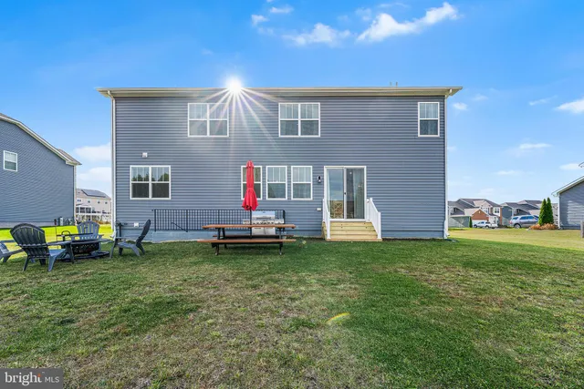 a backyard of a house with table and chairs