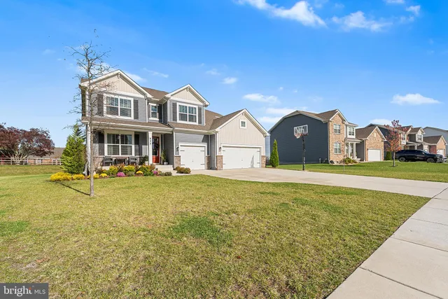 a front view of house with yard and swimming pool