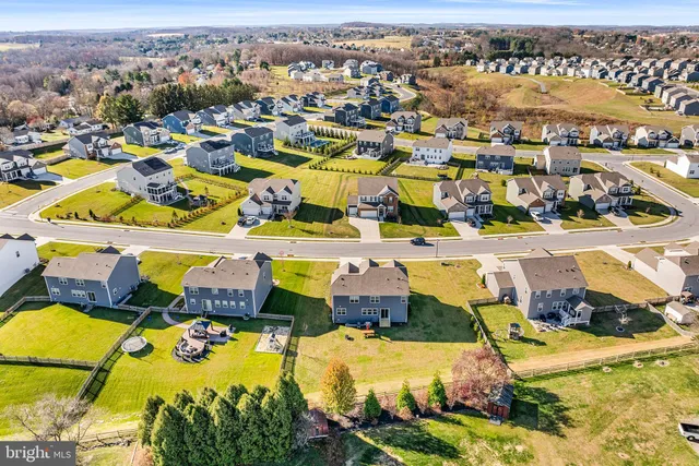 an aerial view of residential houses with outdoor space