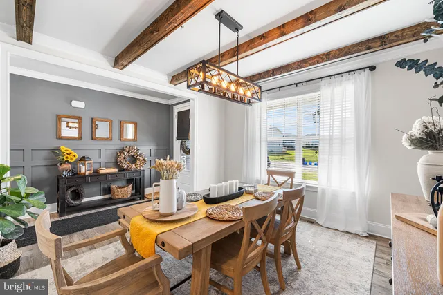a view of a dining room with furniture and a chandelier