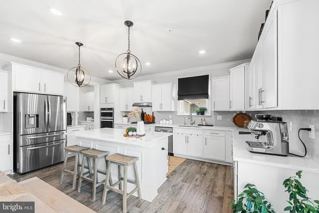 a kitchen with lots of counter space appliances and cabinets