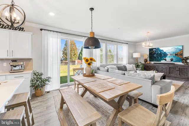 a living room with furniture a window and kitchen view