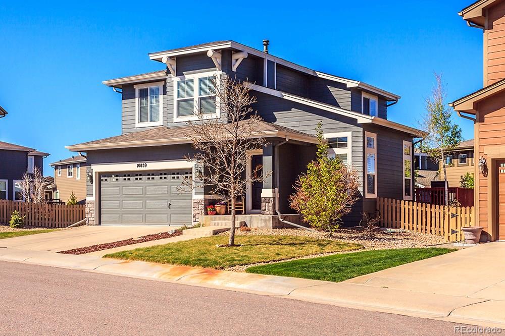 10859 Brooklawn Road Highlands Ranch, CO 80130 - Photo 1 of 1 a front view of a house with a yard