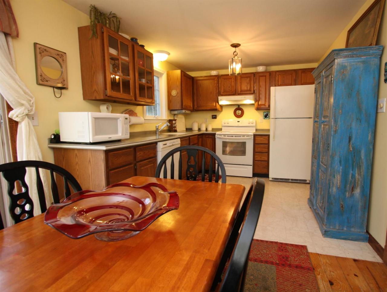 166 Sandy Valley Road Marstons Mills, MA 02648 - Photo 8 of 17 a kitchen with stainless steel appliances granite countertop a refrigerator a stove and a sink with wooden floor