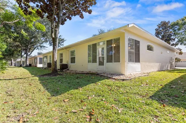 a view of a house with a tree in the yard
