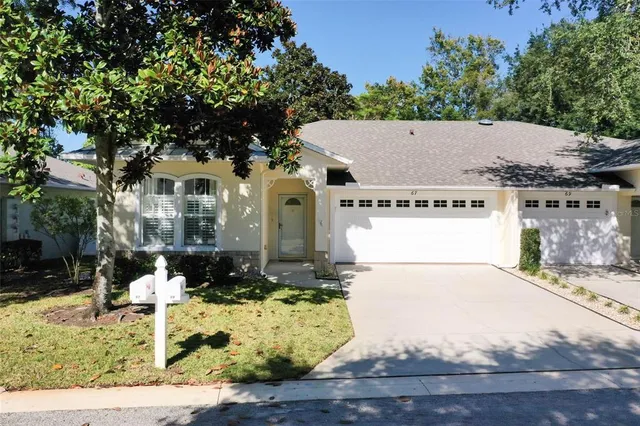 a white house with tree in the background