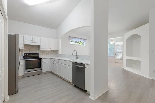 a kitchen with a sink and a stove top oven