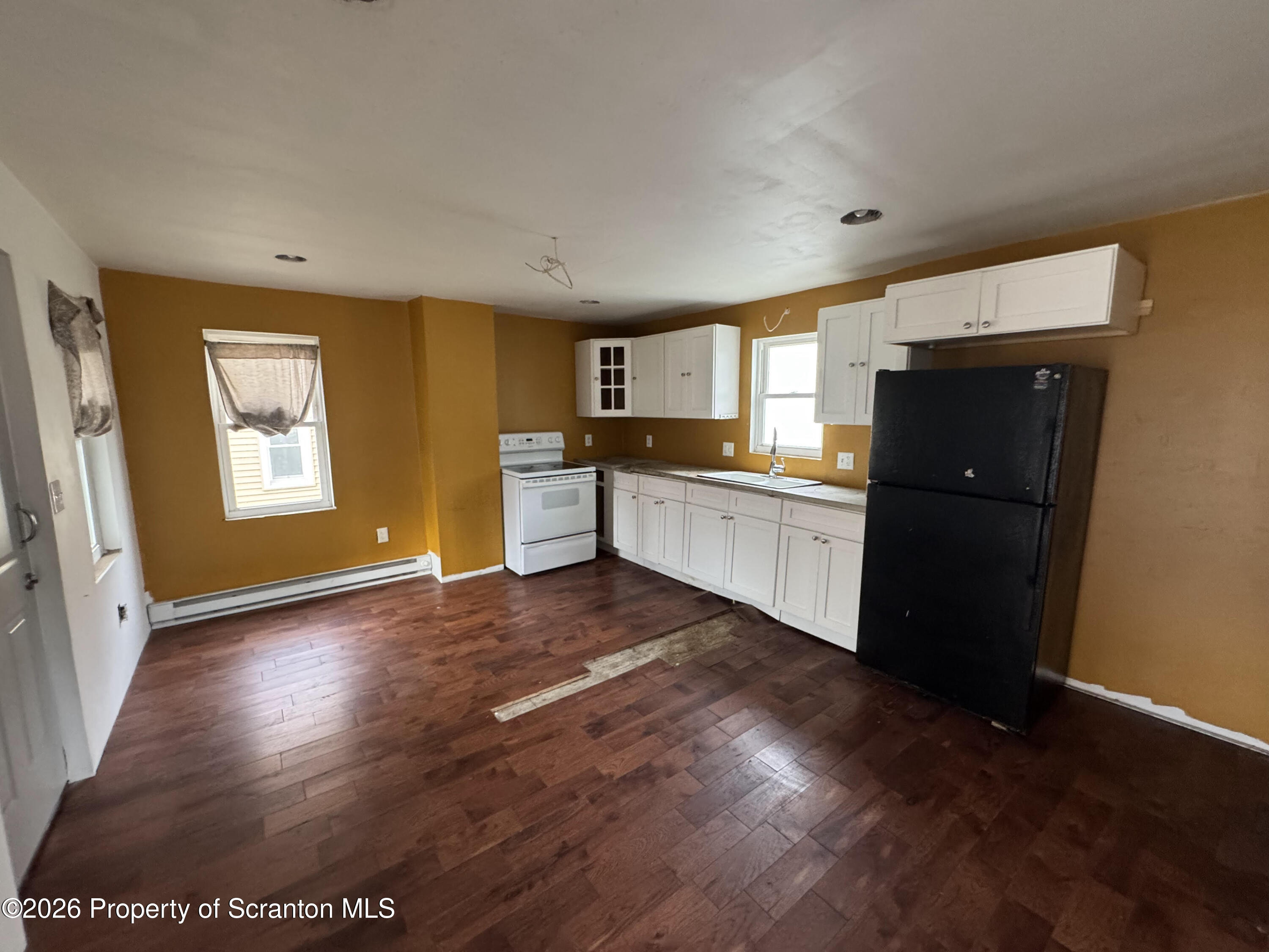 613 East Locust Street Scranton, PA 18505 - Photo 3 of 5 a kitchen with stainless steel appliances granite countertop a refrigerator stove top oven and sink