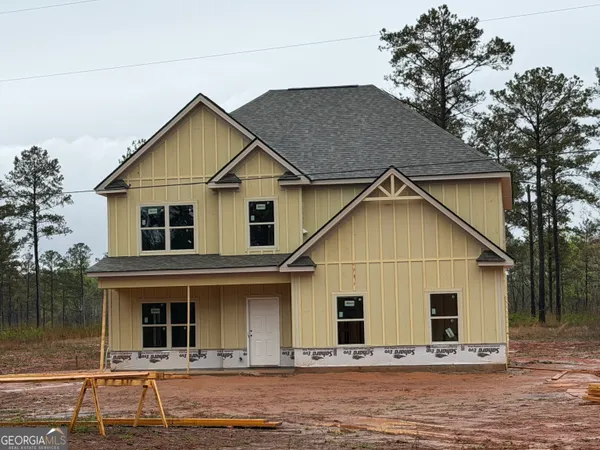 a view of a house with large windows and a yard