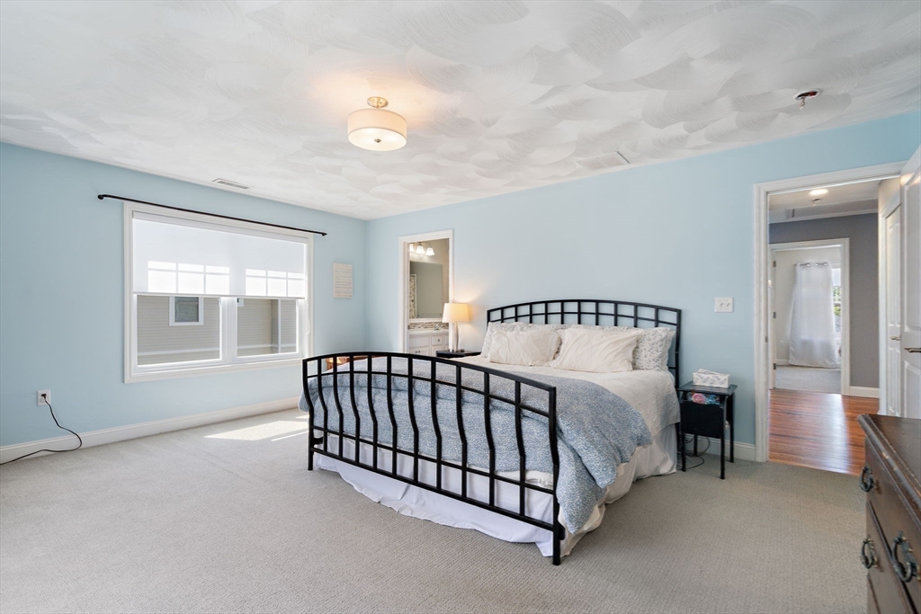 78 Oak Street, Unit 78 Clinton, MA 01510 - Photo 15 of 22 a bed sitting in a bedroom next to a window