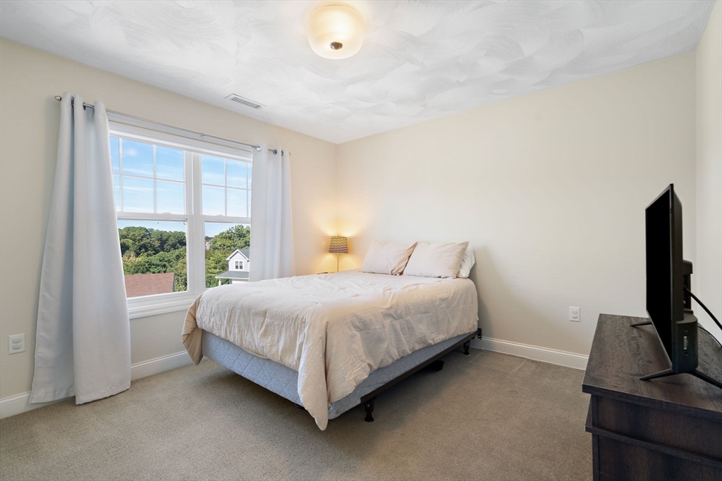 78 Oak Street, Unit 78 Clinton, MA 01510 - Photo 17 of 22 a bedroom with a bed tv and window