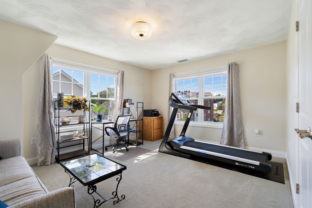 78 Oak Street, Unit 78 Clinton, MA 01510 - Photo 18 of 22 a room with gym equipment and windows