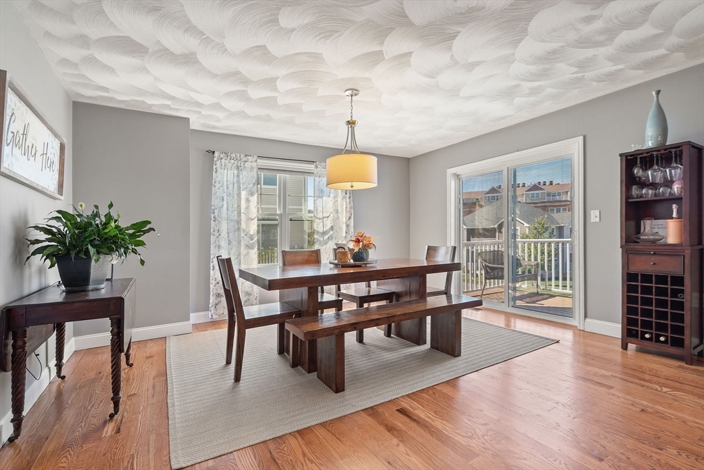78 Oak Street, Unit 78 Clinton, MA 01510 - Photo 3 of 22 a view of a dining room with furniture window and wooden floor