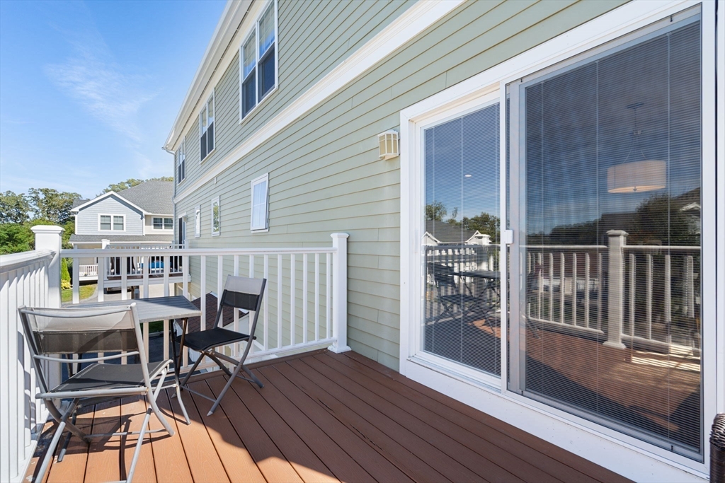 78 Oak Street, Unit 78 Clinton, MA 01510 - Photo 8 of 22 a balcony with table and chairs