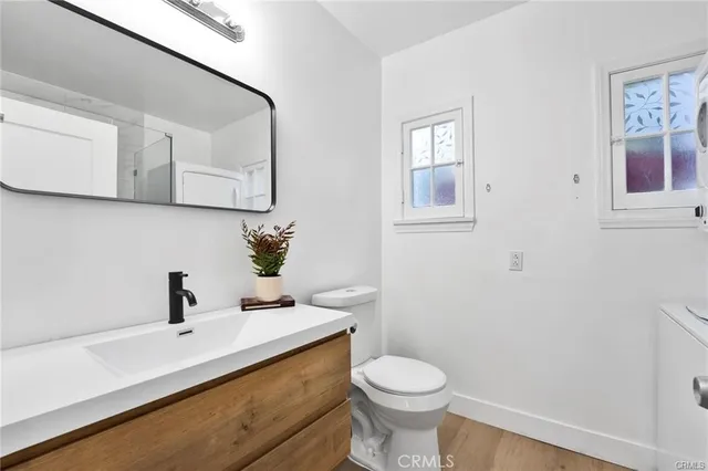 a bathroom with a sink a toilet and mirror