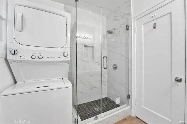 a bathroom with a shower a toilet and a sink