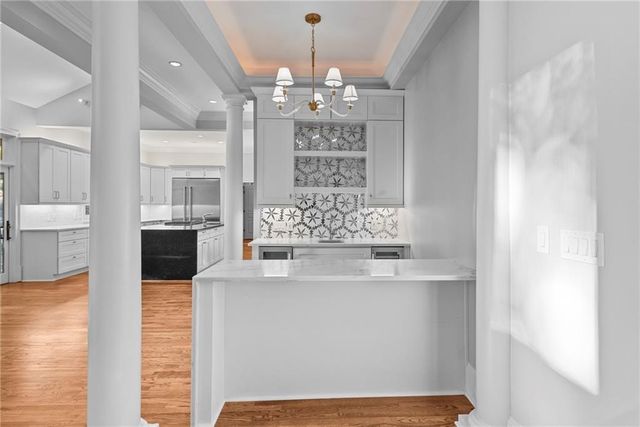 a large kitchen with stainless steel appliances granite countertop a stove and a sink