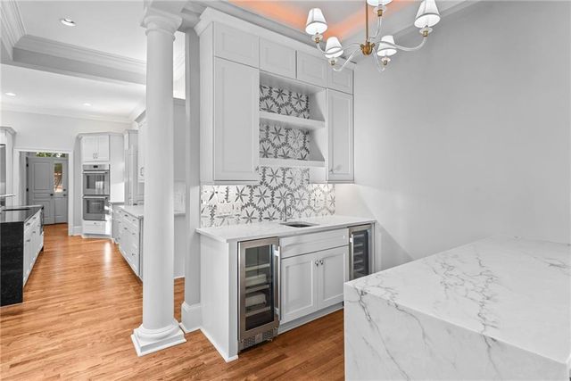 a open kitchen with stainless steel appliances kitchen island granite countertop a stove and a refrigerator