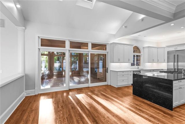 a kitchen with stainless steel appliances granite countertop a stove and a refrigerator