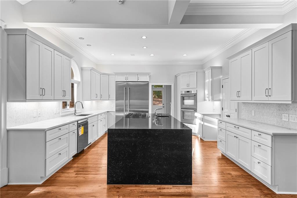 520 Chestnut Rose Lane Sandy Springs, GA 30327 - Photo 20 of 94 a large kitchen with stainless steel appliances kitchen island granite countertop a sink counter space and cabinets