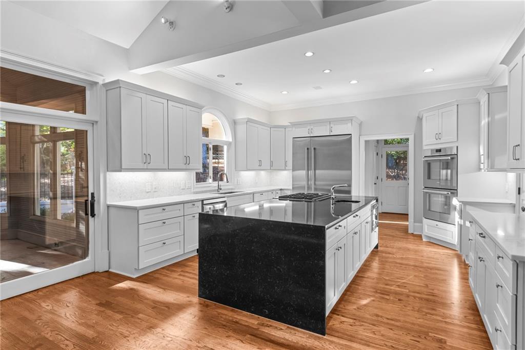 520 Chestnut Rose Lane Sandy Springs, GA 30327 - Photo 24 of 94 a large kitchen with stainless steel appliances granite countertop a stove and a sink