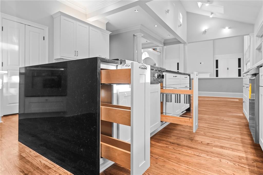 520 Chestnut Rose Lane Sandy Springs, GA 30327 - Photo 25 of 94 a open kitchen with stainless steel appliances kitchen island granite countertop a stove and a refrigerator