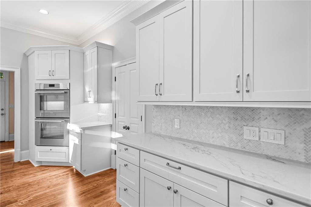 520 Chestnut Rose Lane Sandy Springs, GA 30327 - Photo 27 of 94 a kitchen with granite countertop white cabinets and stainless steel appliances