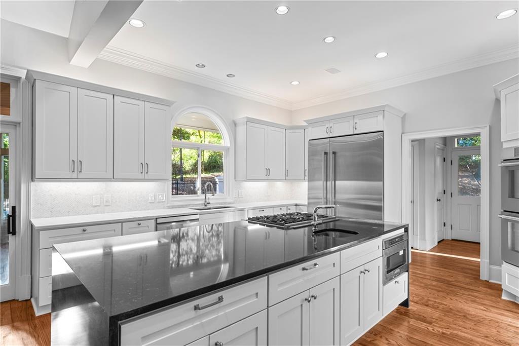 520 Chestnut Rose Lane Sandy Springs, GA 30327 - Photo 29 of 94 a kitchen with granite countertop a sink stainless steel appliances and cabinets