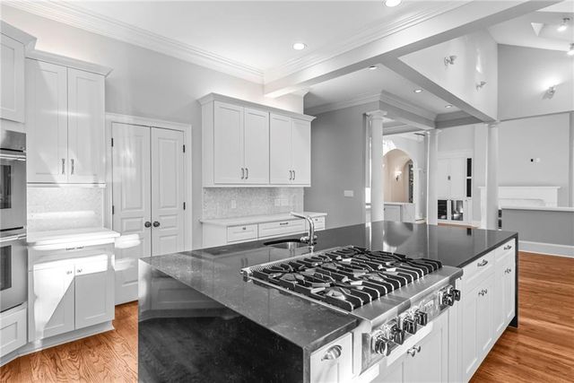 a bathroom with a granite countertop sink a toilet and a mirror