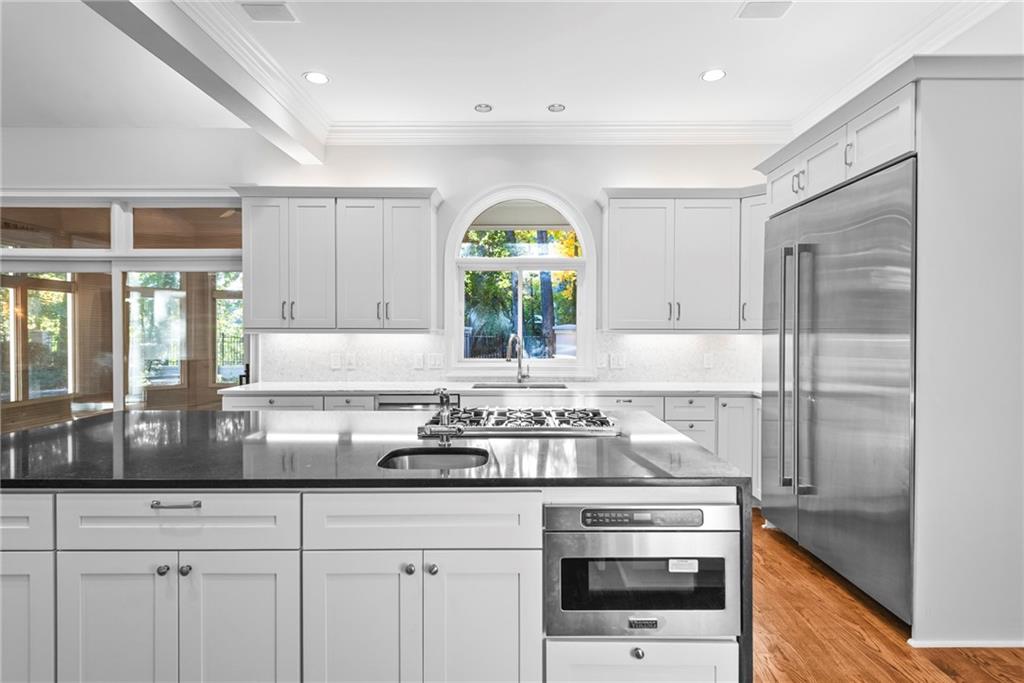 520 Chestnut Rose Lane Sandy Springs, GA 30327 - Photo 32 of 94 a kitchen with stainless steel appliances granite countertop a stove a sink and a granite counter tops with white cabinets