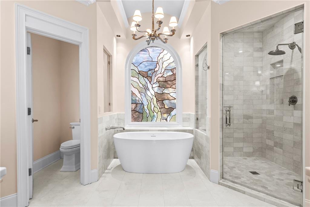 520 Chestnut Rose Lane Sandy Springs, GA 30327 - Photo 44 of 94 a bathroom with a bathtub sink mirror and toilet