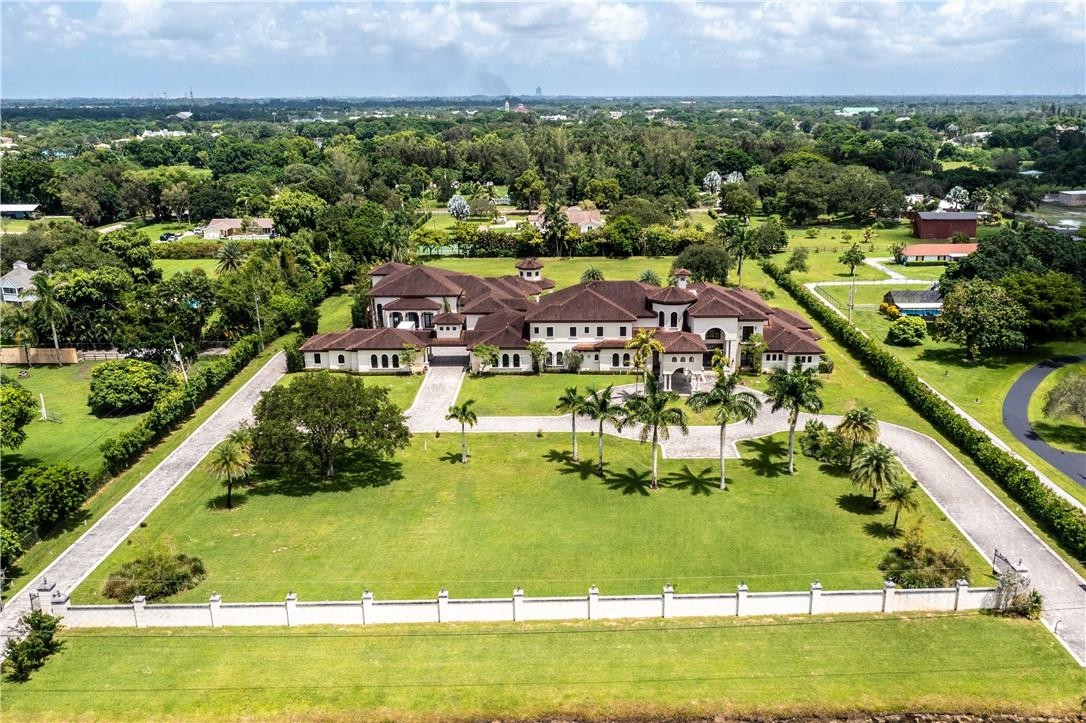 an aerial view of residential houses with outdoor space and swimming pool