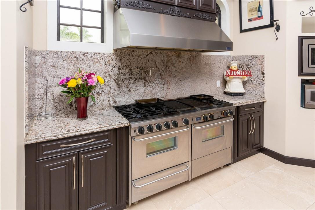 5600 Southwest 136th Avenue Southwest Ranches, FL 33330 - Photo 19 of 32 a kitchen with stainless steel appliances granite countertop a stove and a sink