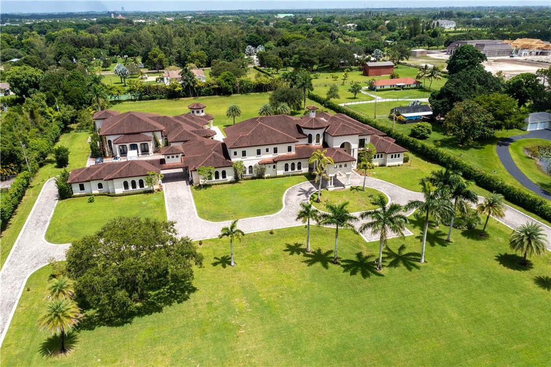 5600 Southwest 136th Avenue Southwest Ranches, FL 33330 - Photo 2 of 32 an aerial view of a house with a garden and lake view