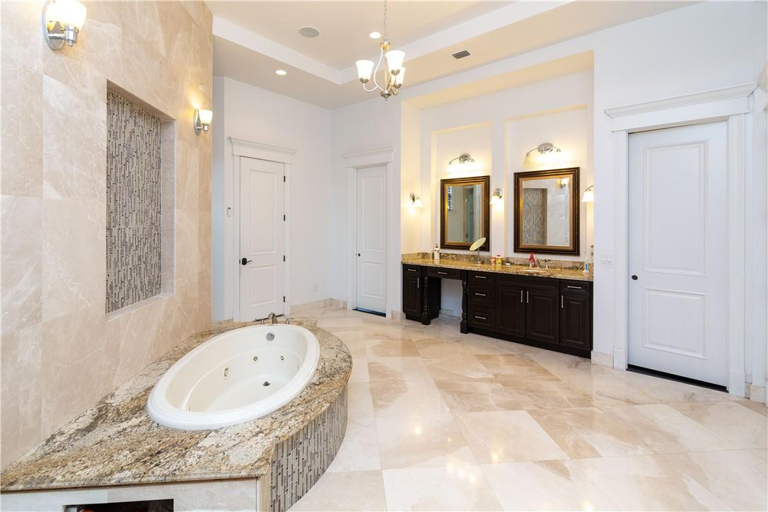5600 Southwest 136th Avenue Southwest Ranches, FL 33330 - Photo 25 of 32 a bathroom with a granite countertop tub sink and mirror