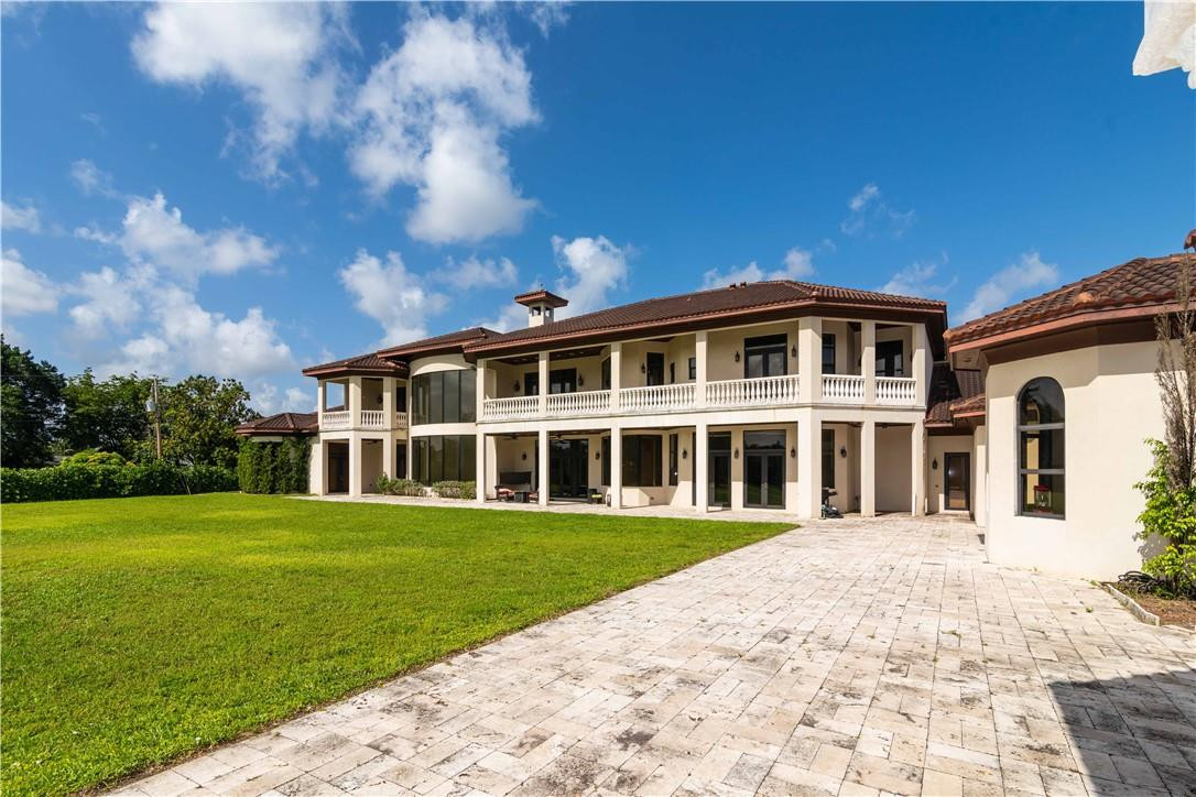 5600 Southwest 136th Avenue Southwest Ranches, FL 33330 - Photo 7 of 32 a front view of a house with a garden and trees