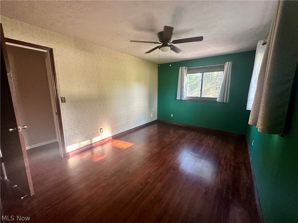5855 Liberty Road Solon, OH 44139 - Photo 13 of 19 Spare room featuring dark hardwood / wood-style floors, ceiling fan, and a textured ceiling