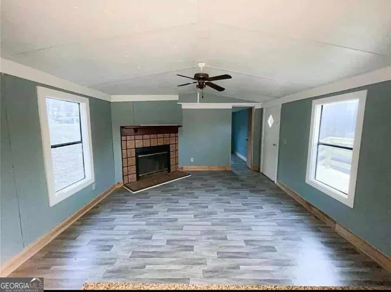 262 Blacks Bluff Road Southwest Rome, GA 30161 - Photo 8 of 16 an empty room with windows and fireplace