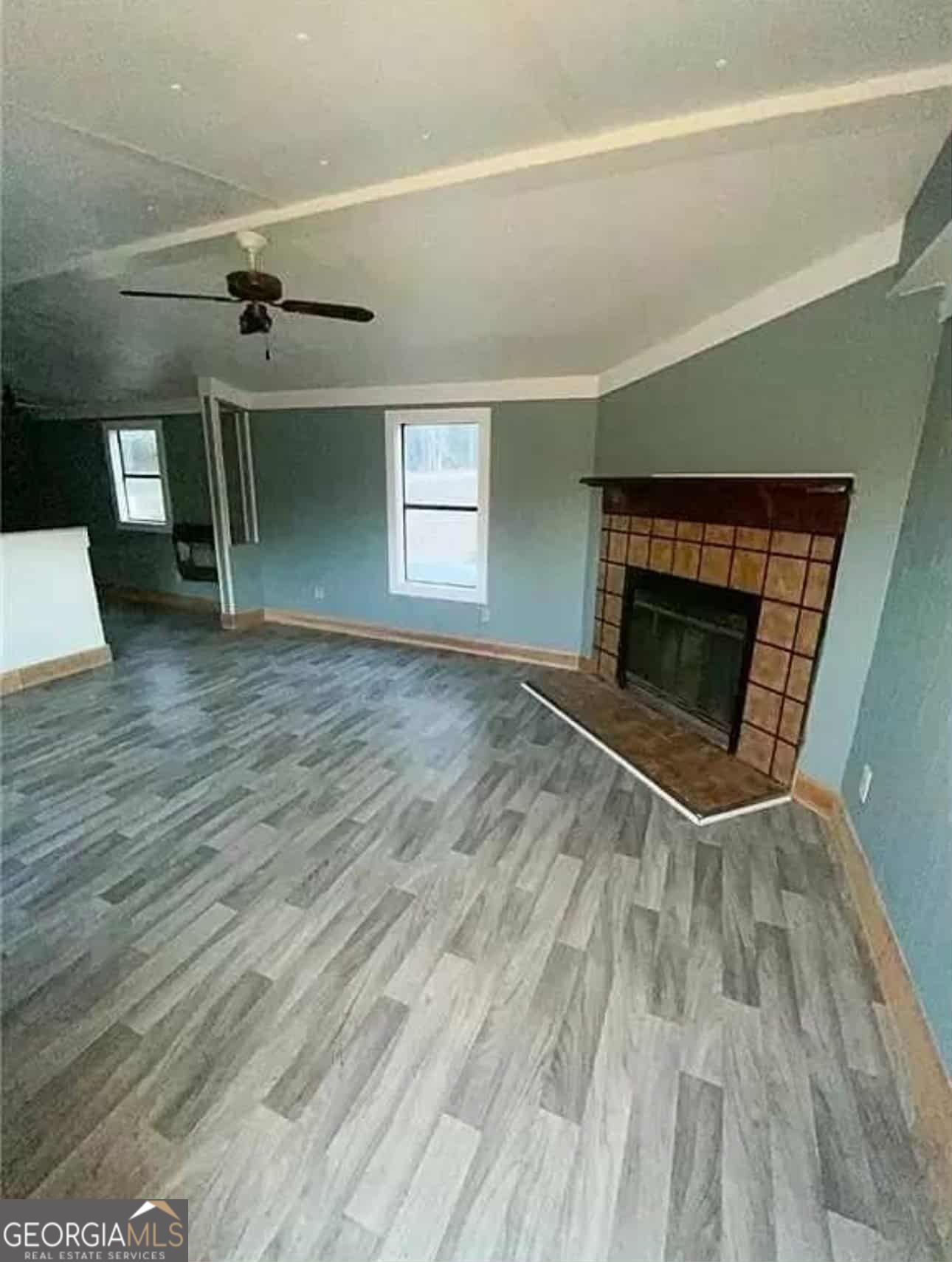 262 Blacks Bluff Road Southwest Rome, GA 30161 - Photo 9 of 16 an empty room with wooden floor fireplace and windows