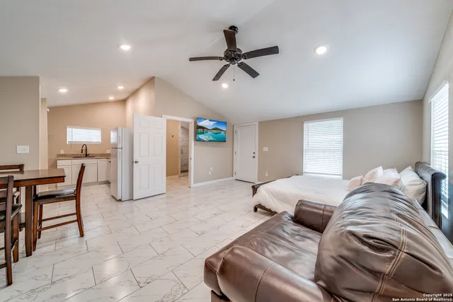 a living room with furniture and a dining table