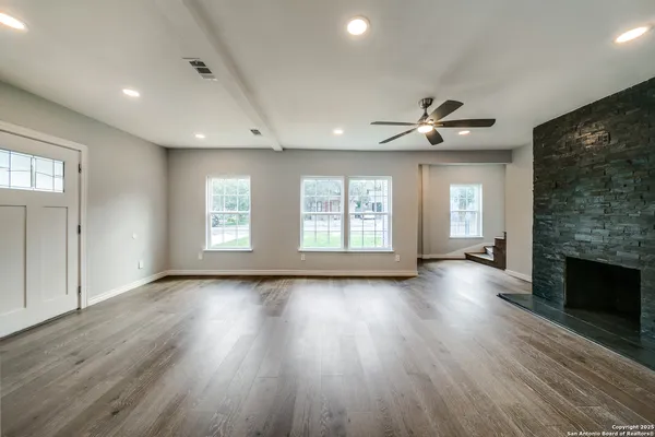 a large kitchen with stainless steel appliances kitchen island a large counter top and a stove