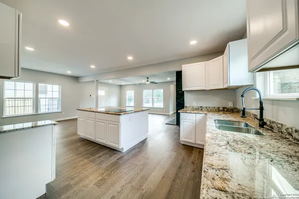 a kitchen with stainless steel appliances granite countertop a stove and a refrigerator