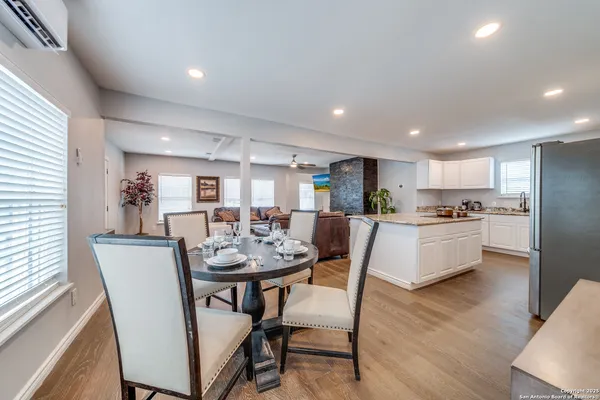 a view of a dining room with furniture and wooden floor