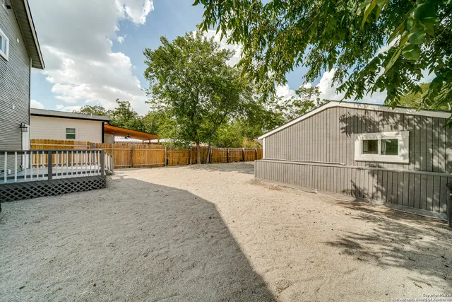 a view of balcony with wooden floor and fence