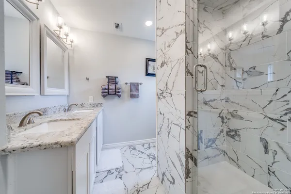 a spacious bathroom with a sink toilet and shower