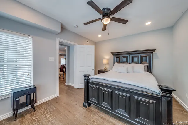 a bedroom with a bed and a ceiling fan