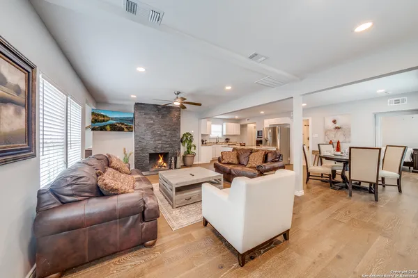 a living room with furniture and a fireplace