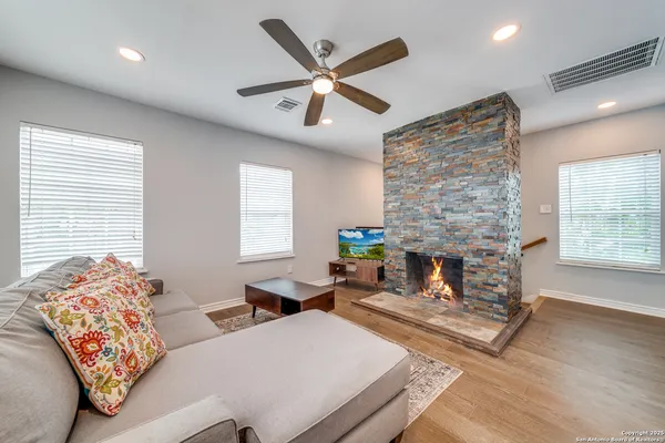 a living room with furniture and a fireplace